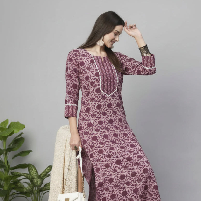 Woman wearing a patterned dress on a gray background